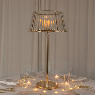 Elegant gold table lamp with a glass shade on a dining table.