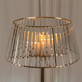 Elegant crystal lamp shade with warm candlelight glow.