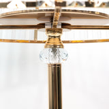 Elegant chandelier detail featuring a crystal accent and gold finish.
