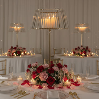 Elegant table setting with floral centerpiece and decorative lamps.