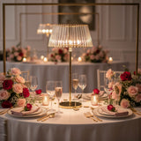 Elegant table setting with floral arrangements and a stylish lamp centerpiece.