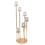 Gold and glass floor lamp with multiple shades in a modern design.