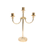 Gold three-armed candle holder with a sleek, modern design #whtbkgd