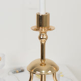 Elegant gold candle holder with a sleek design and a white candle.