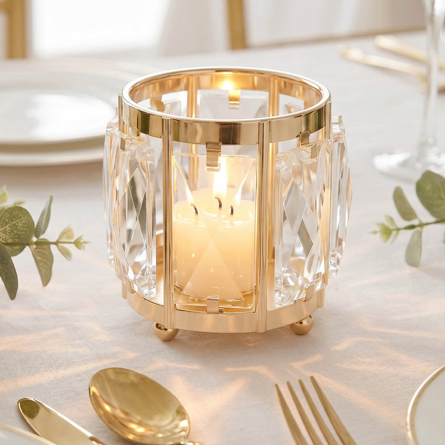 Gold crystal candle holder with lit candle on elegant table setting