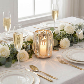 Elegant white and gold wedding table setting with roses and champagne flutes