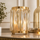 Gold crystal table lamp with geometric glass panels on a marble surface