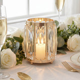 Gold crystal candle holder centerpiece with lit candle and white roses