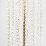 Crystal beaded chandelier with gold accents on a plain backdrop