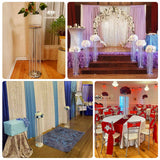 Decorative event setup with floral arrangements and elegant drapery.
