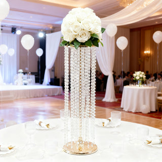 Elegant floral centerpiece with white roses and crystal accents at a wedding event.