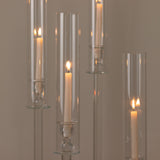 Elegant glass candle holders with lit candles, creating a warm ambiance.
