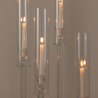 Elegant glass candle holders with lit candles, creating a warm ambiance.