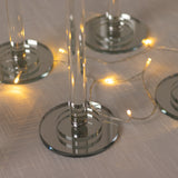 Glass coasters with reflective bases and soft glowing lights.