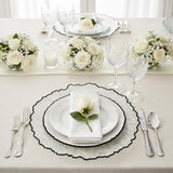 Elegant dining table setting with floral arrangements and crystal glassware.