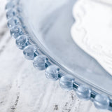 Blue glass dish with decorative bead edge detail. #whtbkgd