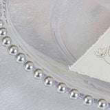 Elegant clear plate with pearl-like edge and floral embossed napkin #whtbkgd