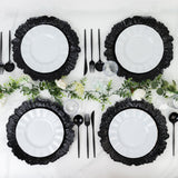Elegant black and white dinnerware set with floral accents on a table.