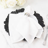 Elegant black plate with white napkin and silver napkin ring