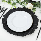 Elegant black and white ruffled dinner plates on a stylish table setting.