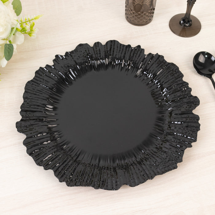 Black decorative plate with a ruffled edge on a light wooden surface.