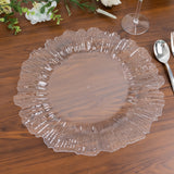 Clear decorative plate with fluted edges on a wooden tabletop.