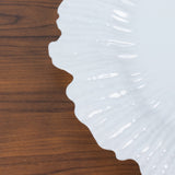 Elegant white ceramic plate with a scalloped edge.