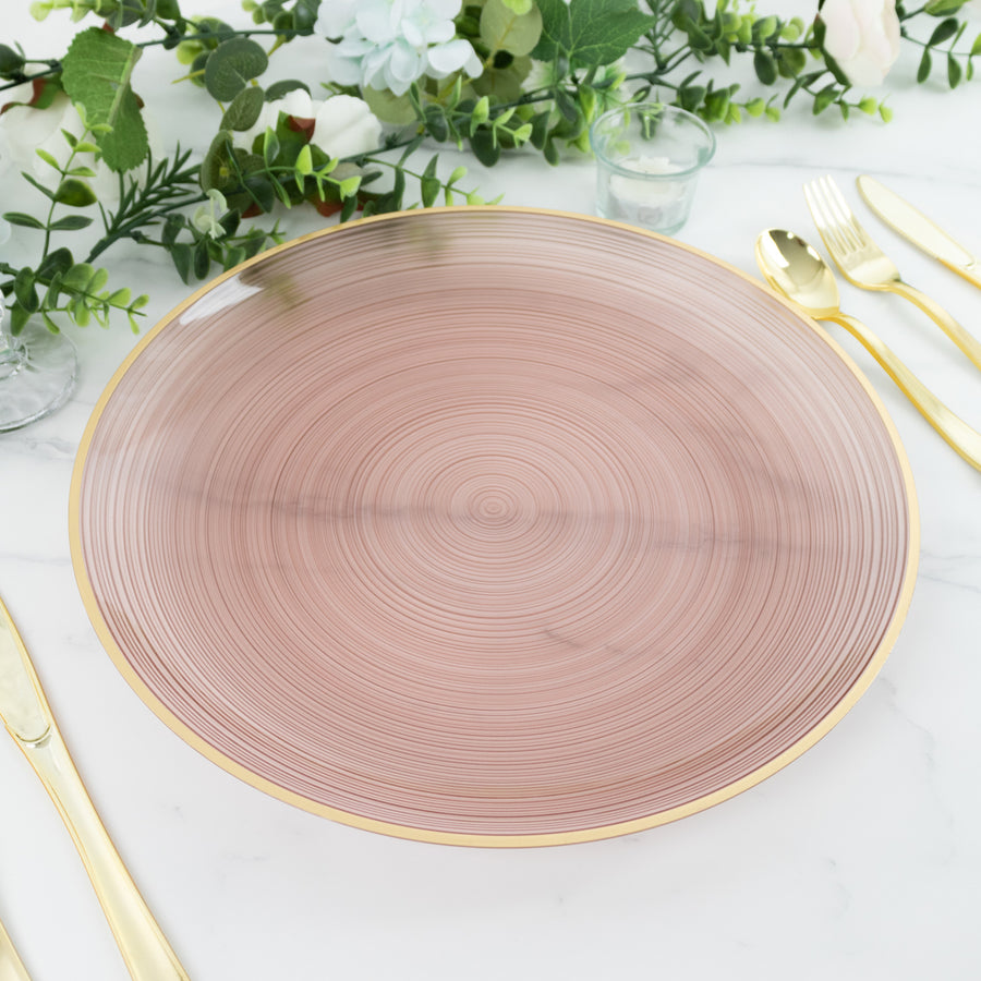 Rose gold decorative plate with spiral design on a marble table setting.