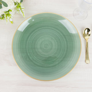 Green decorative plate with gold rim on a wooden table.