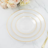 Elegant white plate with gold rim detail, displayed on marble surface.