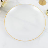 White serving platter with gold rim on marble surface.