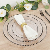 Elegant clear glass charger plate with beaded rim, styled with a white napkin.