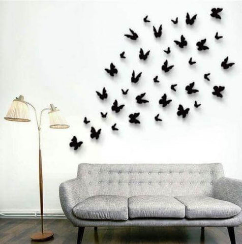 Butterfly wall art above a gray sofa