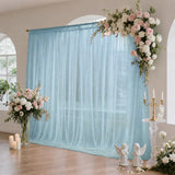 Elegant wedding floral backdrop with blue tulle curtain and candles