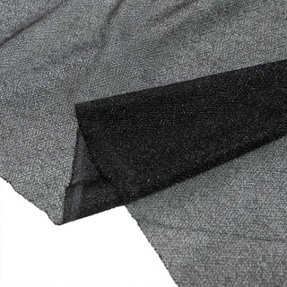 Gray and black fabric close-up with textured woven surface and fold