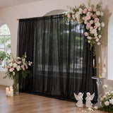Black sheer backdrop with pink and white floral wedding arch decor