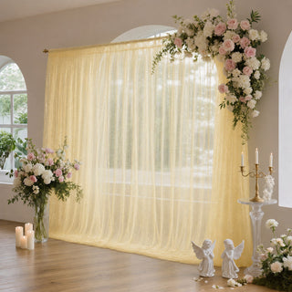 Elegant wedding backdrop with gold sheer curtains and pink white floral arrangements