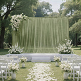 Elegant outdoor wedding ceremony setup with white floral arch and aisle petals