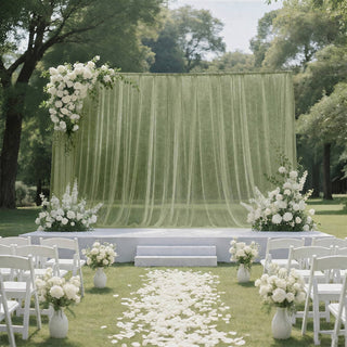 Elegant outdoor wedding ceremony setup with white floral arch and aisle petals