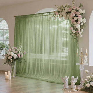 Elegant green wedding backdrop with pink and white floral arrangements and candles
