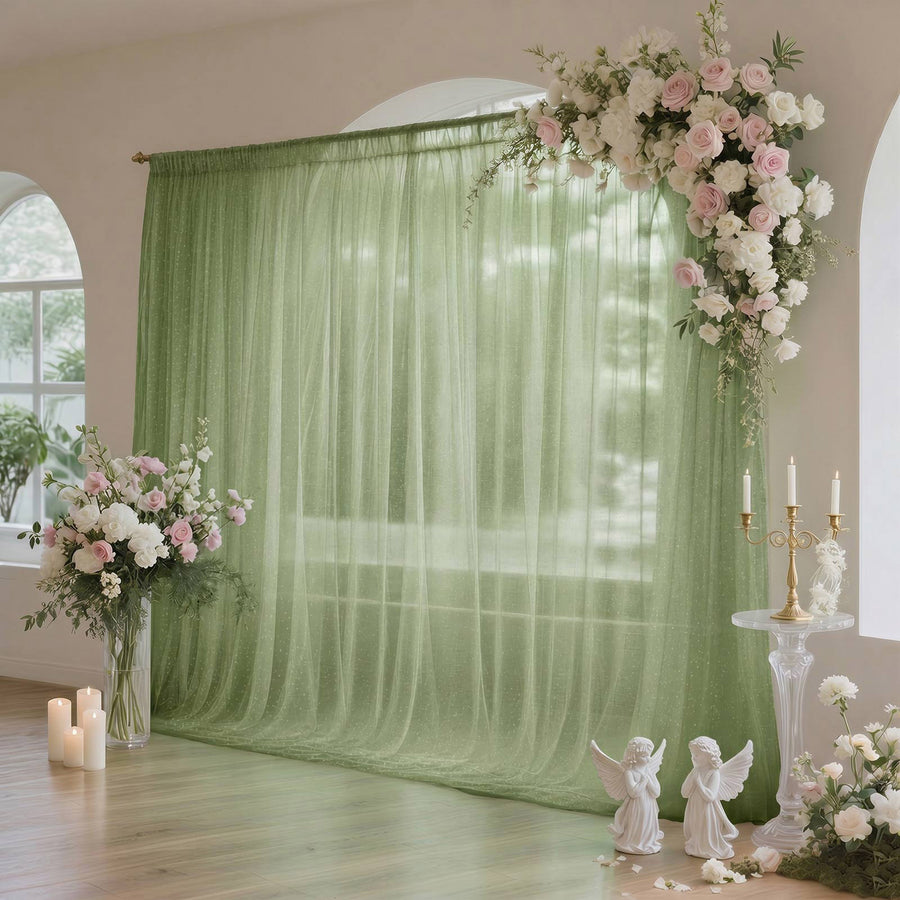 Elegant green wedding backdrop with pink and white floral arrangements and candles