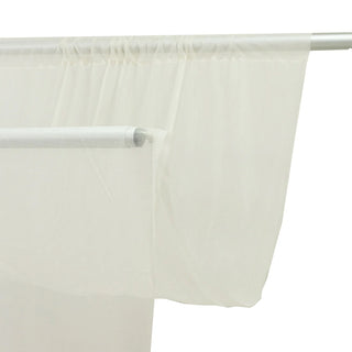 Sheer white curtain panels on a modern curtain rod