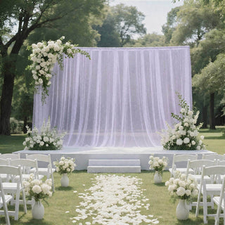 Elegant outdoor wedding ceremony setup with white floral arch and aisle petals