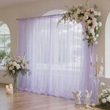 Elegant lavender wedding backdrop with pastel floral arrangements and candles