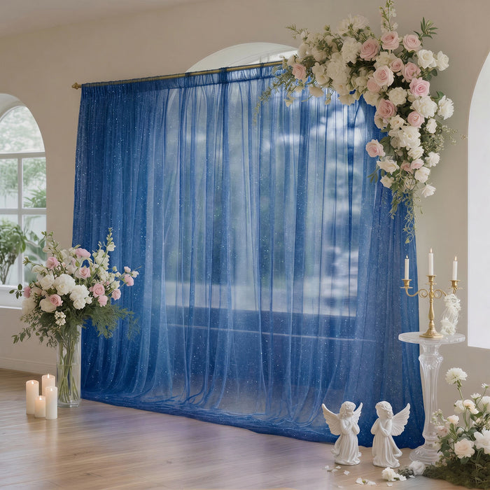 Elegant wedding backdrop with blue sheer curtain, flowers, candles, and angel decor