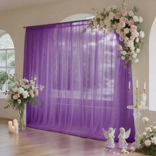 Elegant purple wedding backdrop with floral arrangements and candles