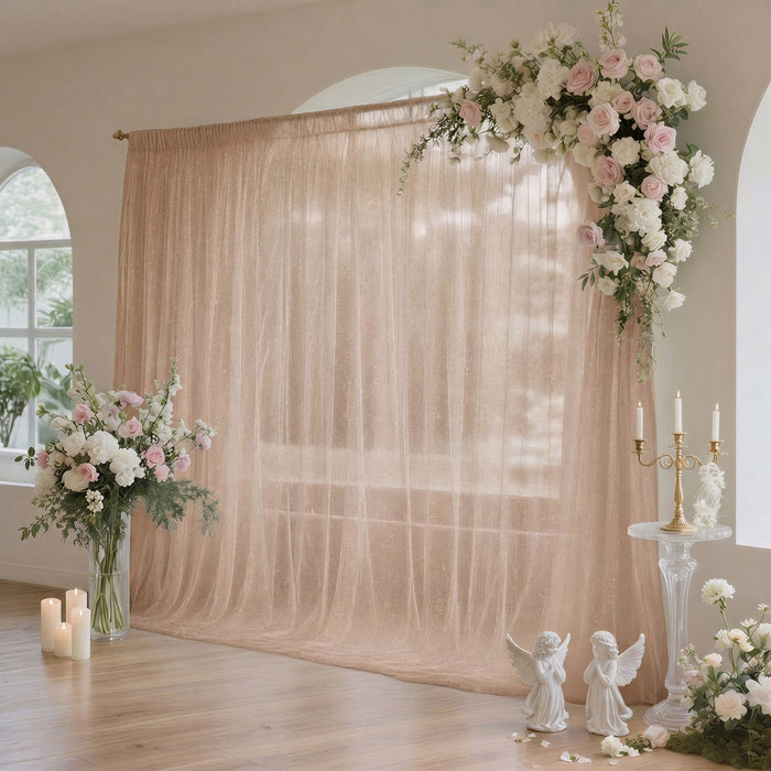 Pastel wedding backdrop with floral arch, candles, and elegant draped curtains