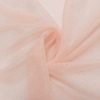 Soft blush pink tulle fabric close-up with delicate folds and shimmer#whtbkgd