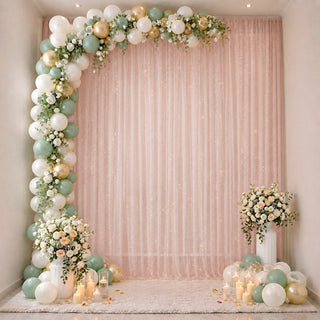 Pastel balloon and floral baby shower backdrop with candles and pink drapes