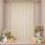 Elegant cream curtain backdrop with floral arrangements and pastel balloons
